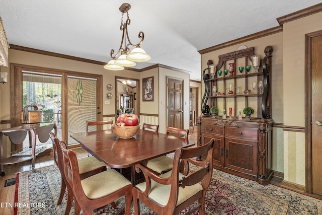 46 Chestnut Dr, Norris, TN 37828 - dining room with ornamental molding, a wainscoted wall, a textured ceiling, and light wood-type flooring