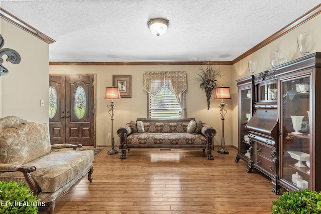 46 Chestnut Dr, Norris, TN 37828 - living area featuring baseboards, a textured ceiling, ornamental molding, and wood-type flooring