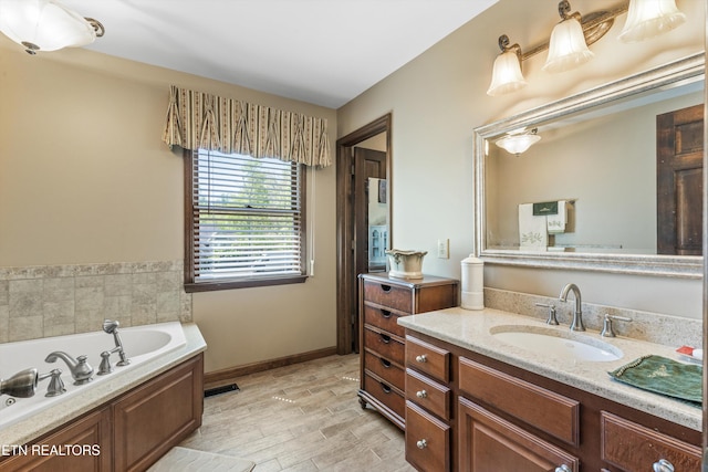 46 Chestnut Dr, Norris, TN 37828 - bathroom with a garden tub, wood finished floors, vanity, baseboards, and visible vents