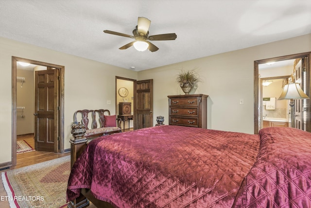 46 Chestnut Dr, Norris, TN 37828 - bedroom with connected bathroom, a ceiling fan, and wood finished floors
