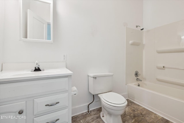bathroom featuring baseboards, toilet, vanity, and  shower combination