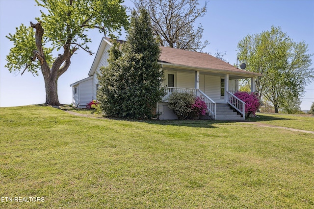 view of front of home featuring a front lawn and covered porch