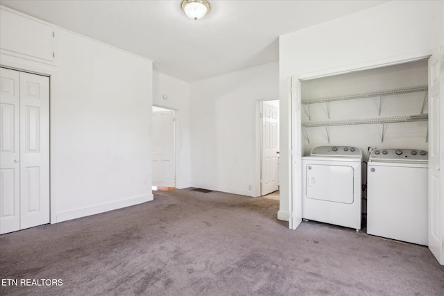 laundry room with baseboards, washer and clothes dryer, light colored carpet, and laundry area
