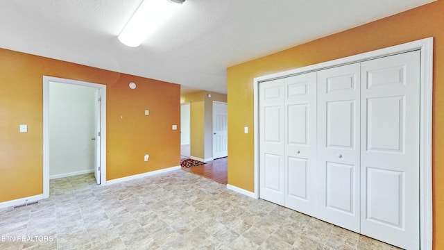 146 Sandy Hill Rd, Lafollette, TN 37766 - unfurnished bedroom with a textured ceiling, a closet, baseboards, and visible vents
