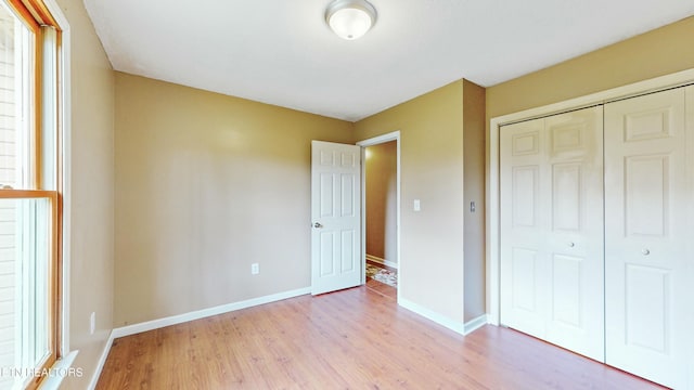 146 Sandy Hill Rd, Lafollette, TN 37766 - unfurnished bedroom featuring baseboards, light wood finished floors, and a closet