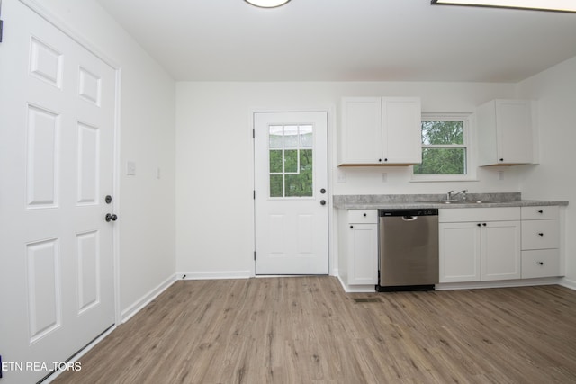 kitchen featuring white cabinets, stainless steel dishwasher, a healthy amount of sunlight, and light wood finished floors
