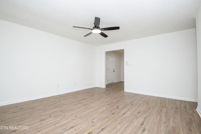 empty room with baseboards, light wood-style floors, and ceiling fan