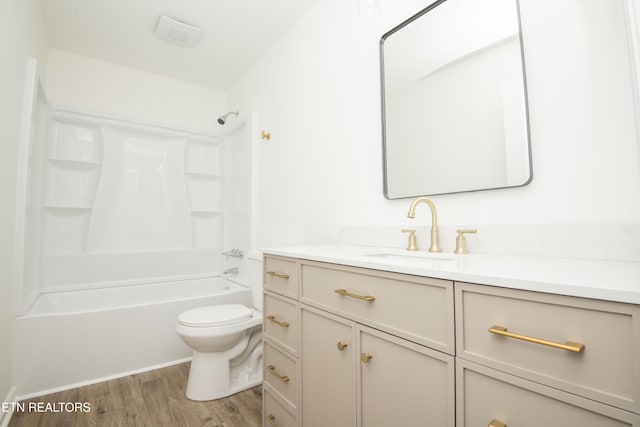 full bathroom with toilet, shower / bathtub combination, vanity, and wood finished floors