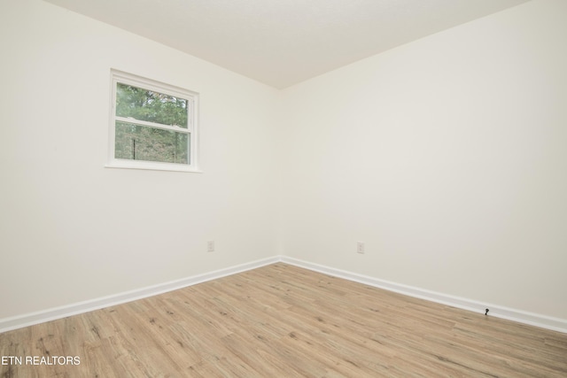 unfurnished room with light wood-style floors and baseboards