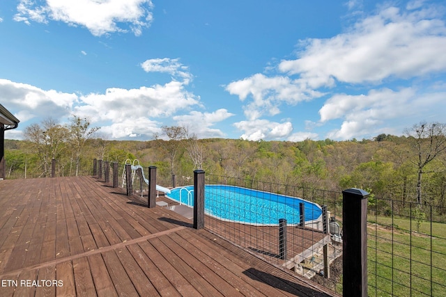 544 Mill Creek Rd, Andersonville, TN 37705 - view of swimming pool featuring a fenced in pool, a water slide, fence, a view of trees, and a deck