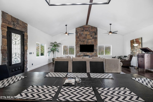 544 Mill Creek Rd, Andersonville, TN 37705 - living area with dark wood finished floors, a stone fireplace, a ceiling fan, beam ceiling, and high vaulted ceiling