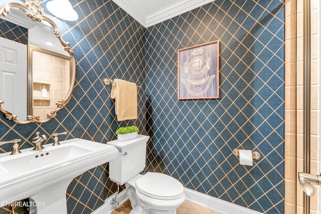bathroom featuring crown molding, tile patterned flooring, toilet, and a sink