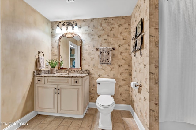 bathroom featuring vanity, toilet, a shower with shower curtain, baseboards, and visible vents