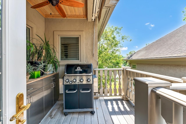 wooden deck featuring a ceiling fan and grilling area