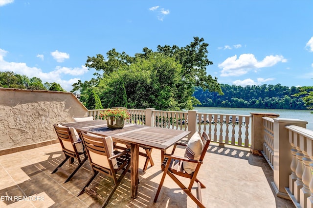 view of patio / terrace with outdoor dining area and a water view