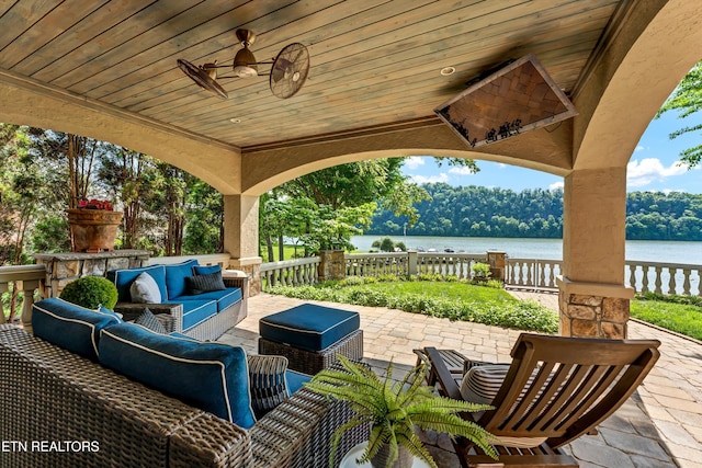 view of patio with a water view and outdoor lounge area