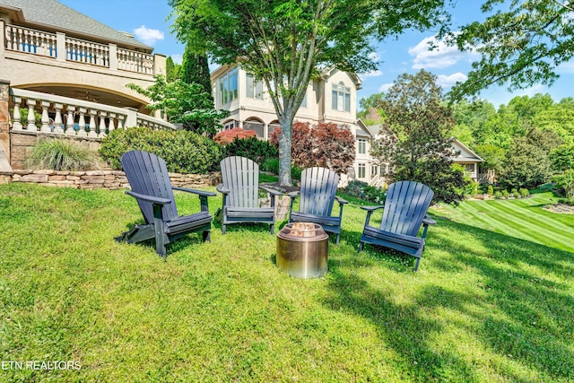 view of yard with a fire pit