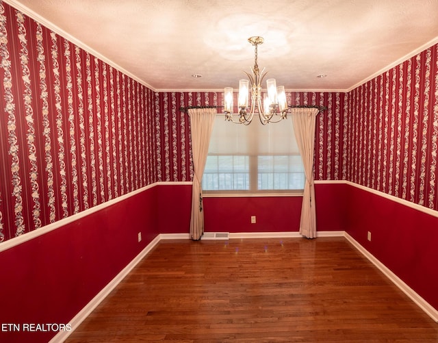 23 Windhaven Ln, Oak Ridge, TN 37830 - unfurnished dining area featuring ornamental molding, wood finished floors, a chandelier, and visible vents