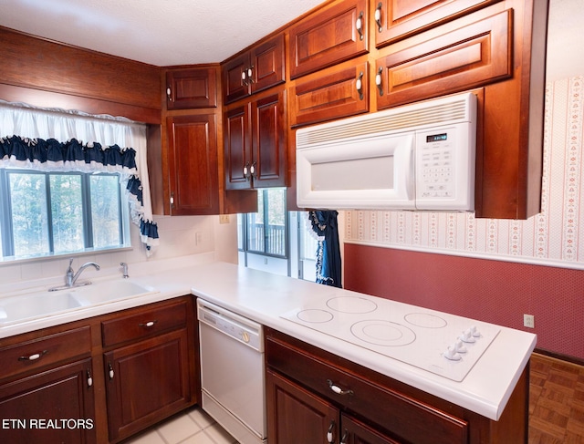 23 Windhaven Ln, Oak Ridge, TN 37830 - kitchen with a peninsula, a sink, wallpapered walls, white appliances, and light countertops