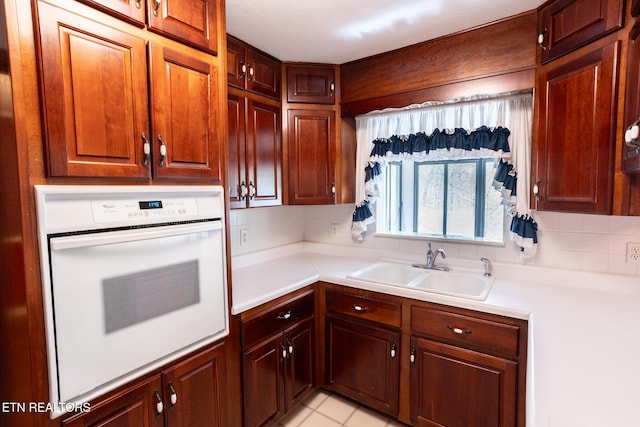 23 Windhaven Ln, Oak Ridge, TN 37830 - kitchen with white oven, light countertops, a sink, and backsplash