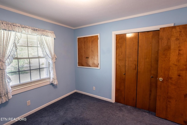 23 Windhaven Ln, Oak Ridge, TN 37830 - unfurnished bedroom featuring dark colored carpet, baseboards, a closet, and crown molding