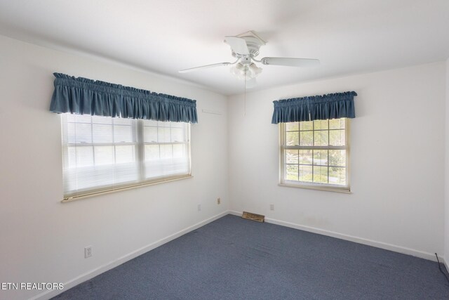 23 Windhaven Ln, Oak Ridge, TN 37830 - unfurnished room featuring plenty of natural light, a ceiling fan, baseboards, and dark carpet