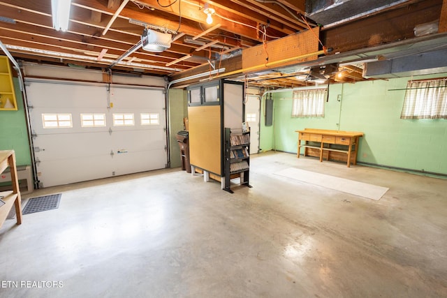 23 Windhaven Ln, Oak Ridge, TN 37830 - garage featuring electric panel, a workshop area, and a garage door opener