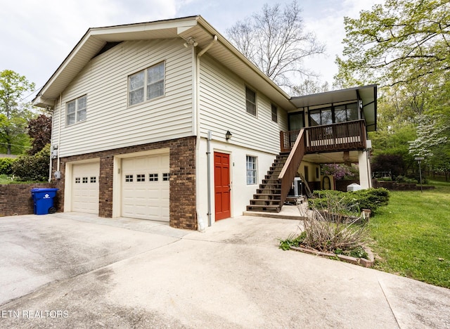 23 Windhaven Ln, Oak Ridge, TN 37830 - view of property exterior with stairway, an attached garage, a wooden deck, driveway, and brick siding