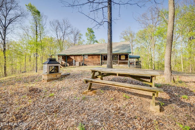 rear view of property with metal roof