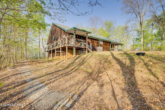 rear view of house with a wooden deck