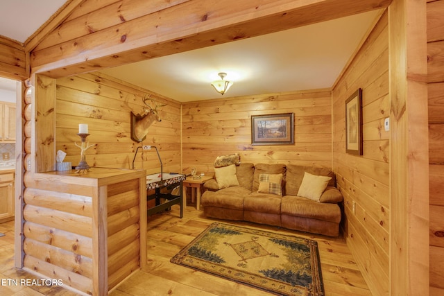 living area featuring wooden walls and light wood-style floors