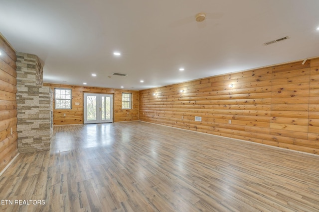 unfurnished room featuring recessed lighting, wood finished floors, visible vents, and rustic walls