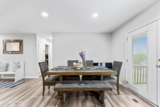 dining space with baseboards, light wood-style floors, visible vents, and recessed lighting