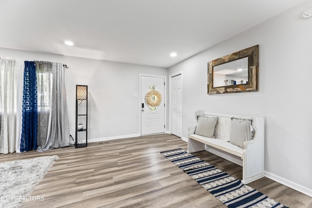 entrance foyer with recessed lighting, wood finished floors, and baseboards