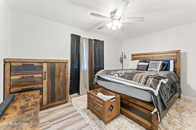 bedroom featuring a ceiling fan and wood finished floors