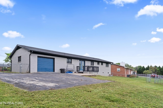 back of house featuring fence, aphalt driveway, and brick siding