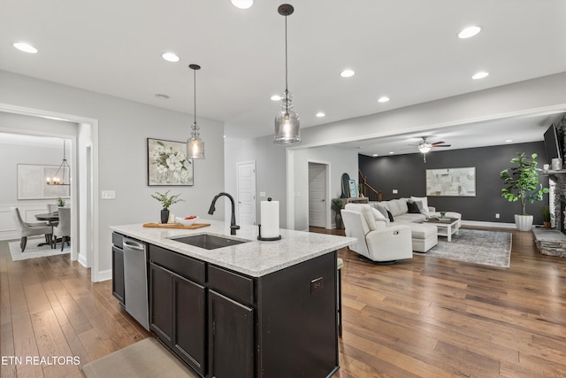 kitchen with a kitchen island with sink, recessed lighting, a sink, a ceiling fan, and dark wood finished floors