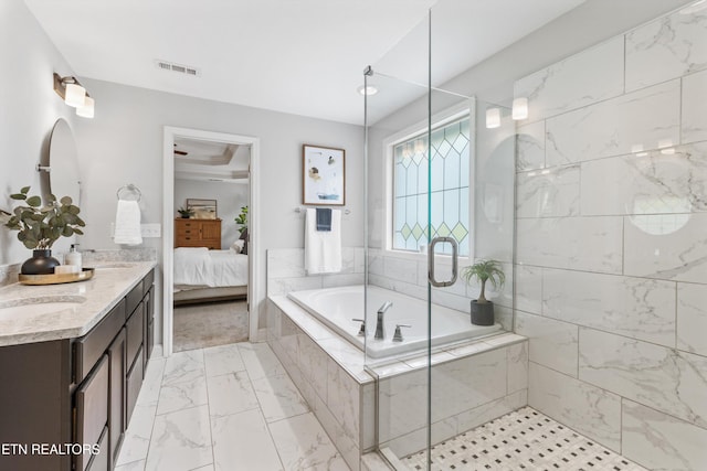 ensuite bathroom featuring visible vents, connected bathroom, a garden tub, and a stall shower