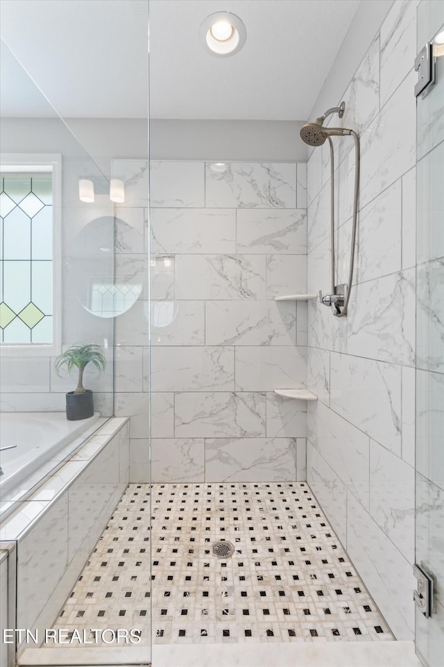 full bath with a stall shower and a bath
