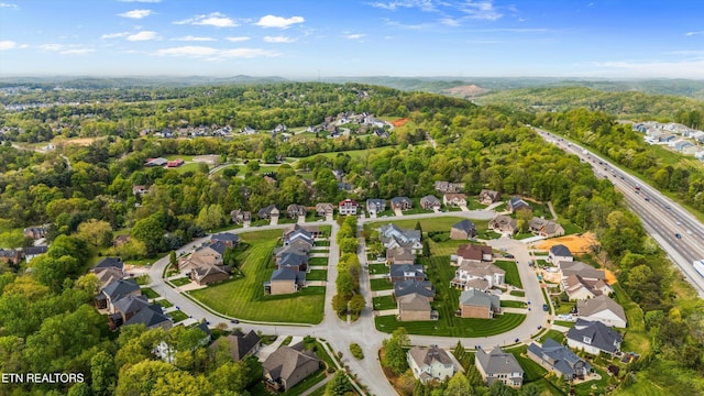 birds eye view of property featuring a residential view and a view of trees