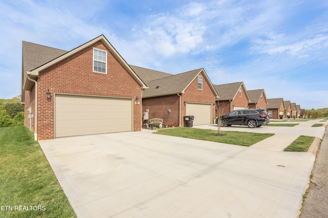 view of front of home with brick siding, driveway, and a front yard