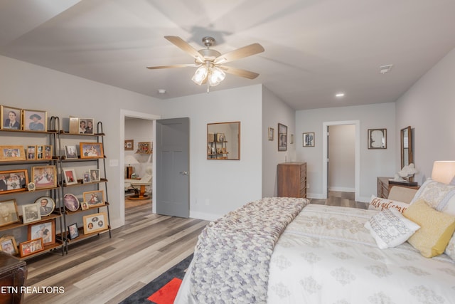 bedroom featuring ceiling fan, baseboards, wood finished floors, and recessed lighting