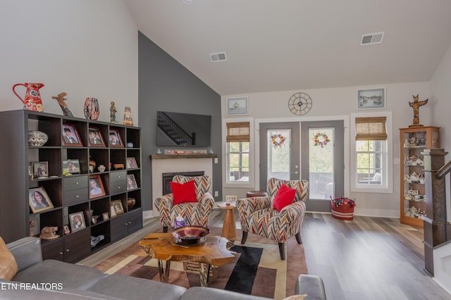 living area with a wealth of natural light, wood finished floors, and visible vents