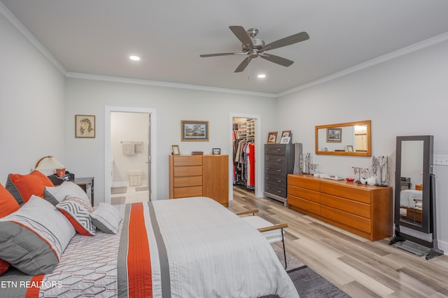bedroom featuring recessed lighting, a spacious closet, light wood-style floors, a closet, and ornamental molding
