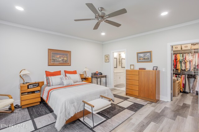bedroom with recessed lighting, light wood-style floors, a closet, crown molding, and a walk in closet