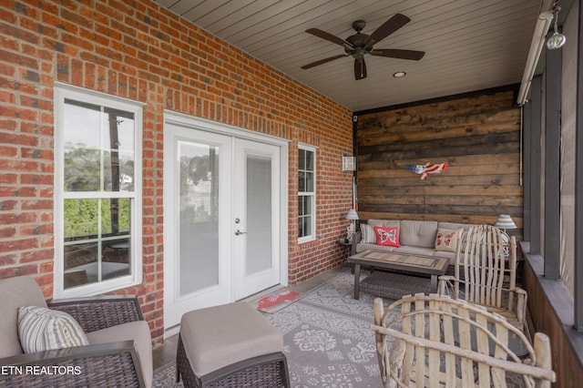 sunroom / solarium featuring outdoor lounge area, a ceiling fan, and french doors