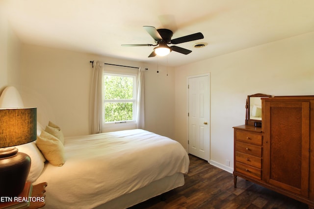 bedroom featuring ceiling fan, baseboards, dark wood-type flooring, and visible vents