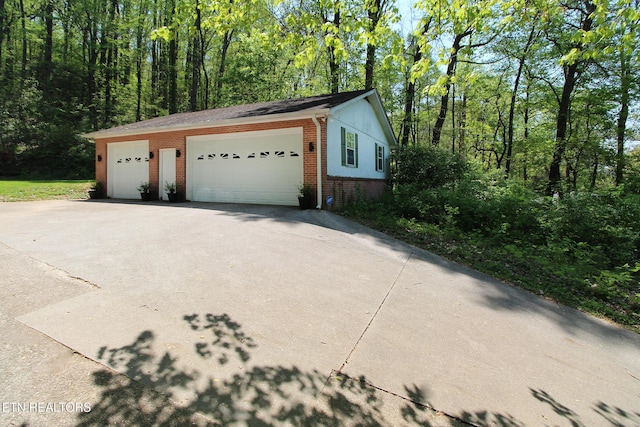 view of property exterior featuring brick siding and an outdoor structure