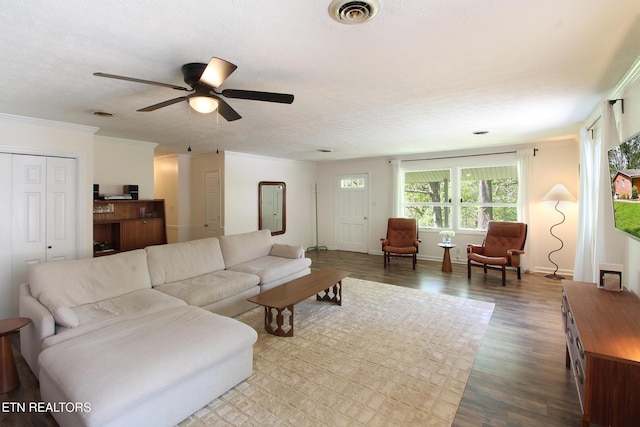 living room featuring ornamental molding, a ceiling fan, wood finished floors, and visible vents