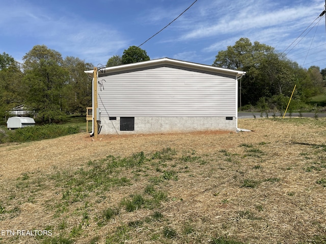 view of side of home with crawl space